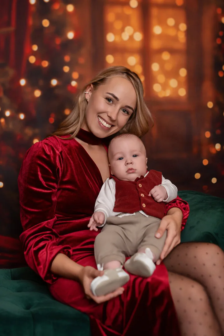 Mama z niemowlęciem podczas czerwonej sesji świątecznej